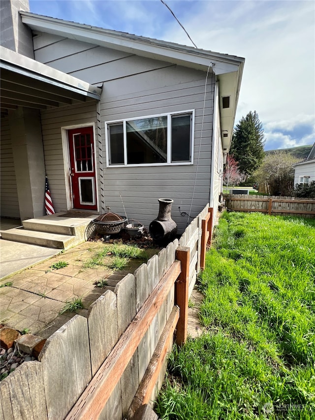 view of side of home with a patio area