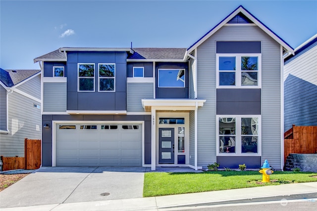 view of front facade with a front lawn and a garage