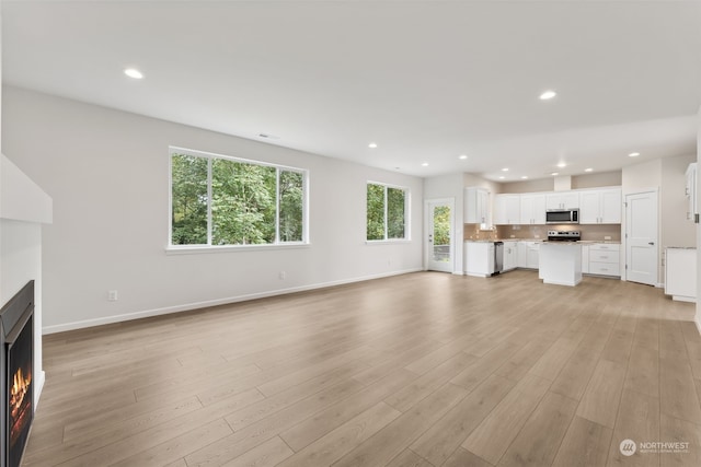 unfurnished living room with light hardwood / wood-style floors