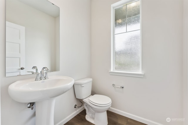 bathroom featuring hardwood / wood-style flooring, plenty of natural light, and toilet