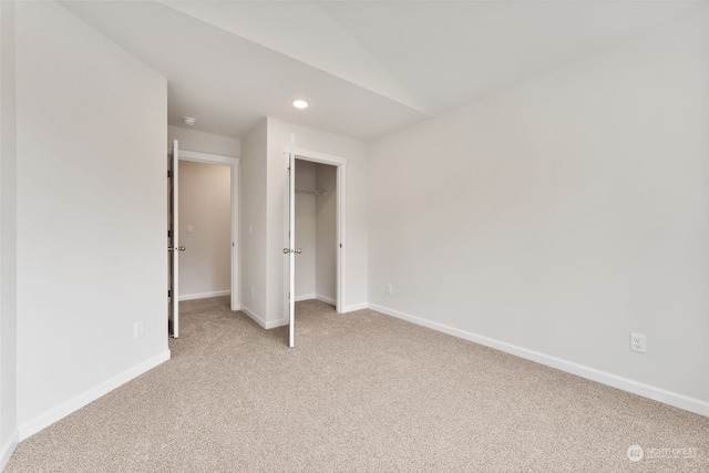 unfurnished bedroom with light colored carpet