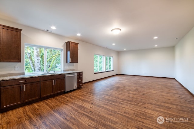 kitchen featuring dark brown cabinetry, light stone countertops, sink, dark hardwood / wood-style flooring, and stainless steel dishwasher