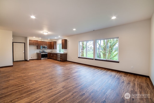 unfurnished living room with dark hardwood / wood-style flooring