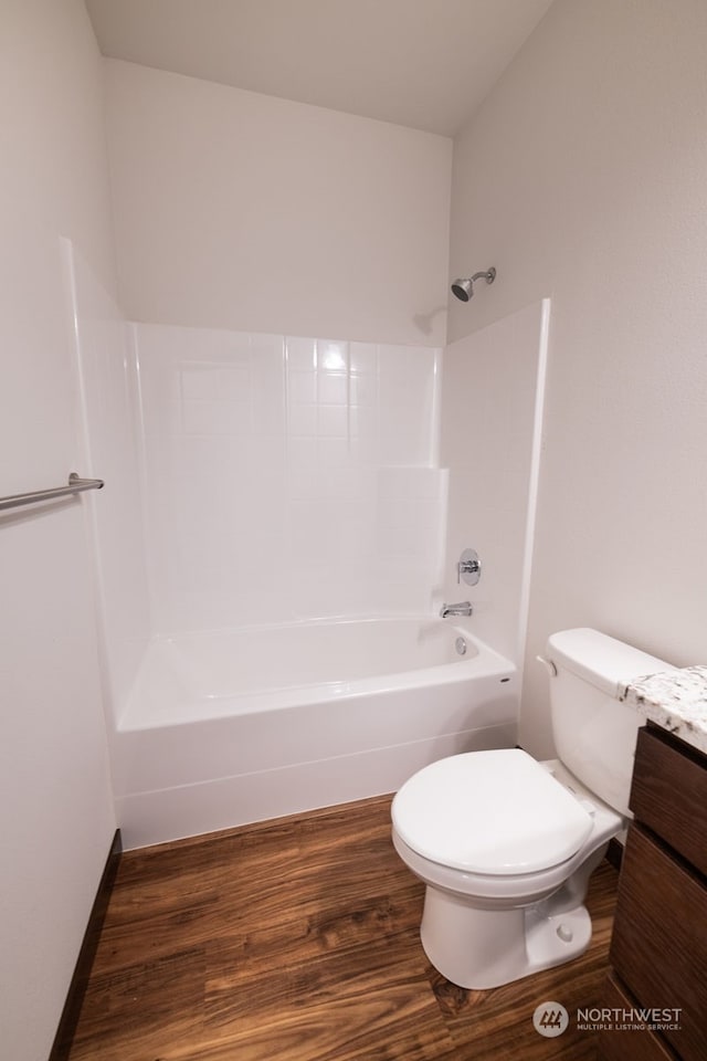 full bathroom featuring wood-type flooring, vanity, toilet, and shower / washtub combination