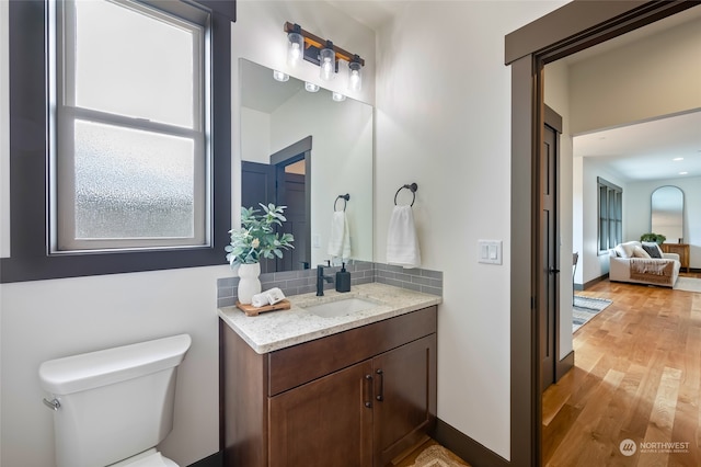 bathroom featuring hardwood / wood-style floors, vanity, and toilet