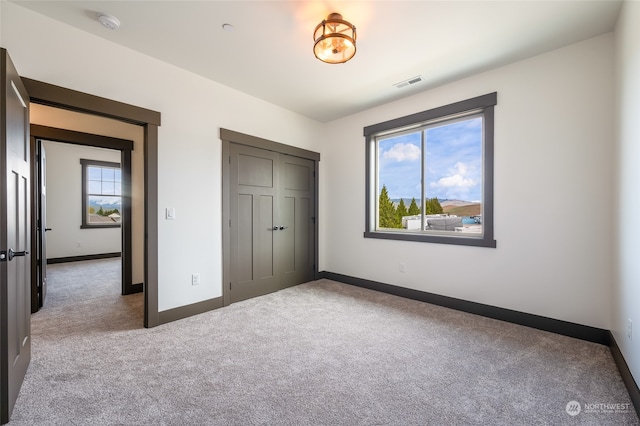 unfurnished bedroom featuring a closet and carpet