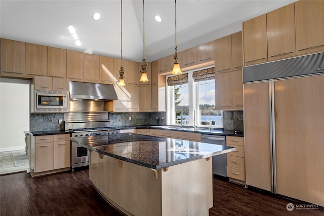 kitchen featuring a center island, dark hardwood / wood-style flooring, and built in appliances