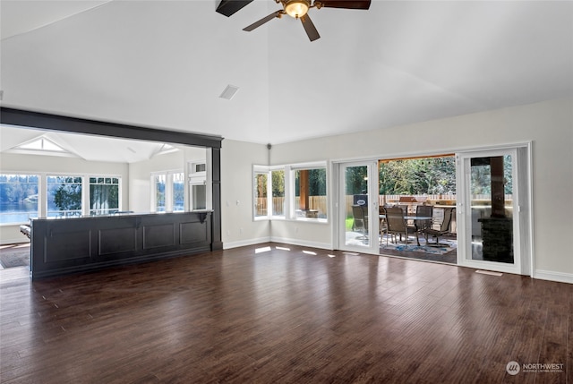 unfurnished living room with high vaulted ceiling, dark hardwood / wood-style floors, and ceiling fan