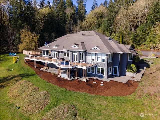 back of house with a yard and a patio