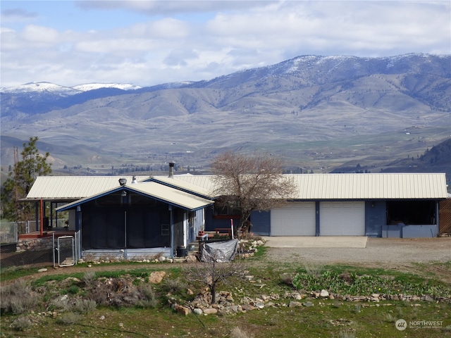 view of front of home featuring a mountain view and a garage