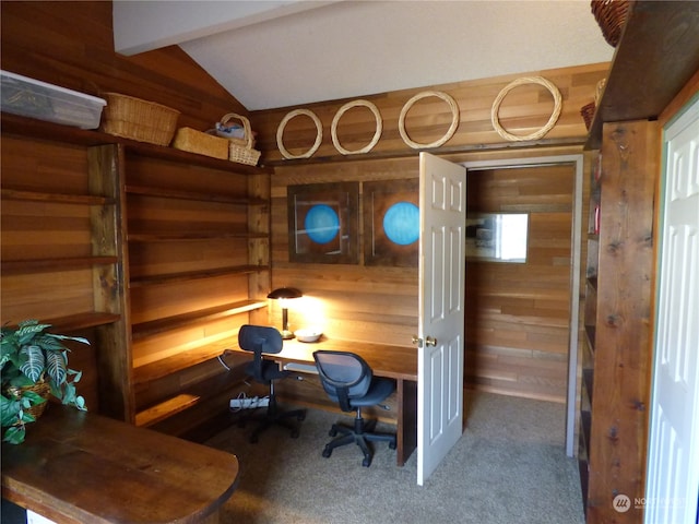 carpeted office with wood walls and vaulted ceiling with beams