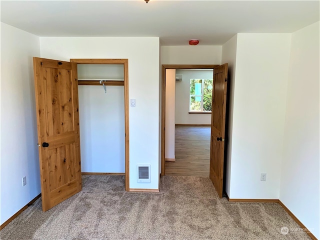 unfurnished bedroom featuring a closet and carpet floors