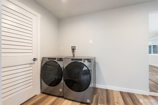 laundry room with washer hookup, separate washer and dryer, and light hardwood / wood-style flooring