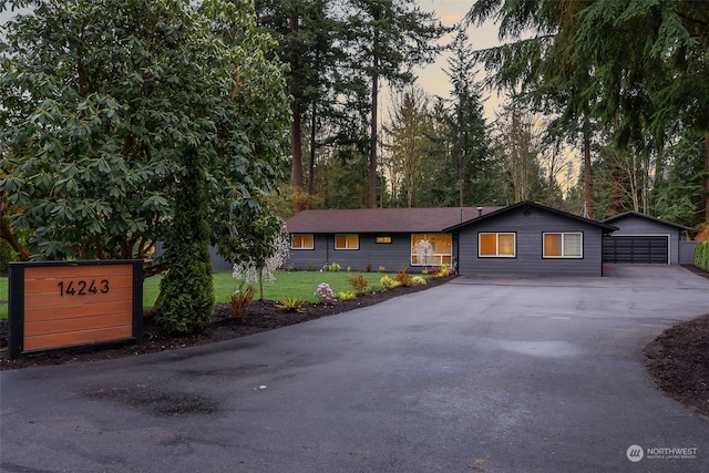 single story home with a yard and a garage