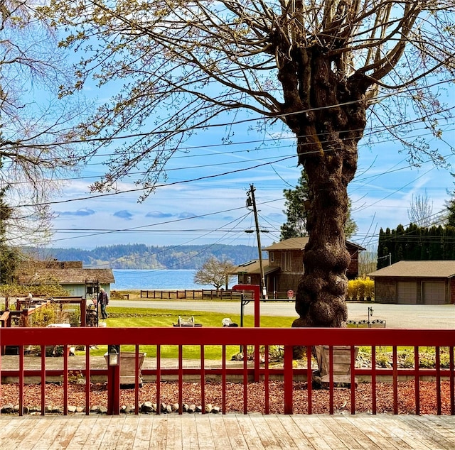 surrounding community featuring a water view and a lawn