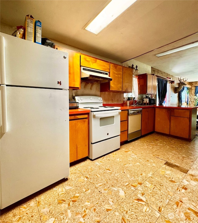 kitchen with white appliances and light tile floors