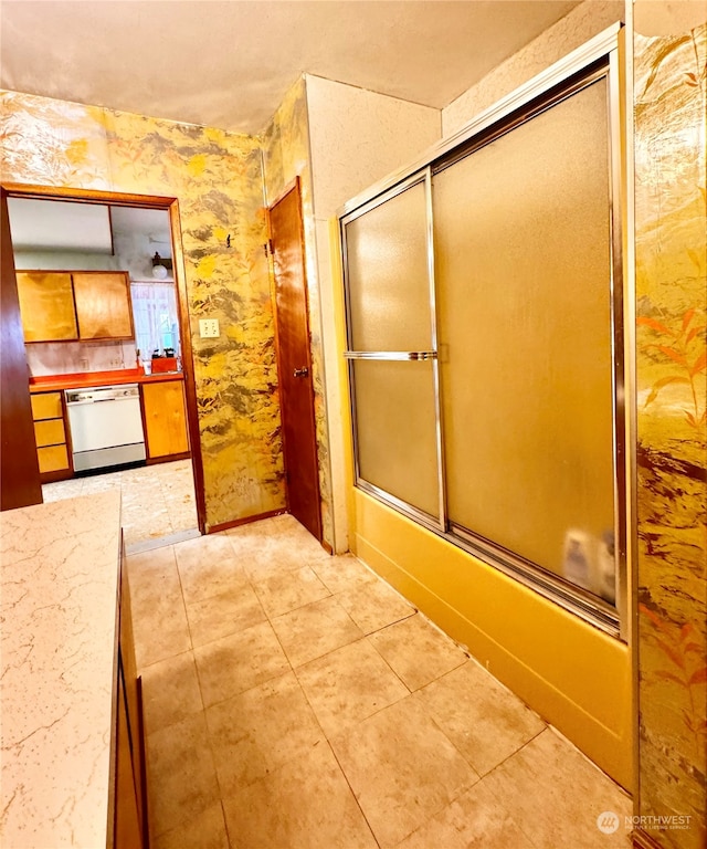 bathroom featuring shower / bath combination with glass door and tile floors