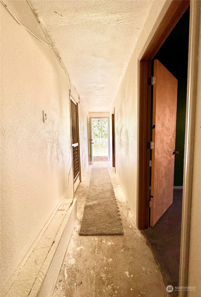 corridor featuring a textured ceiling