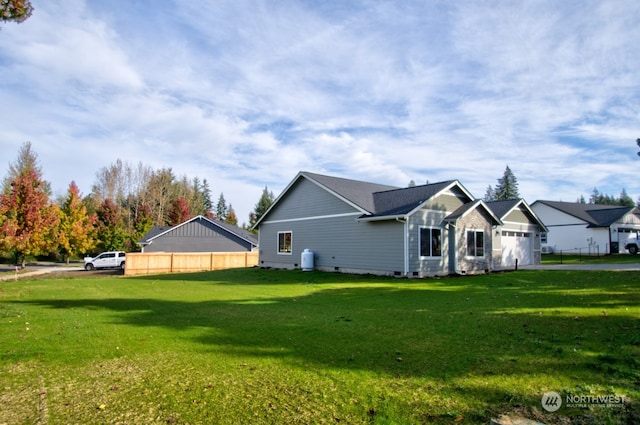 view of side of property with a yard