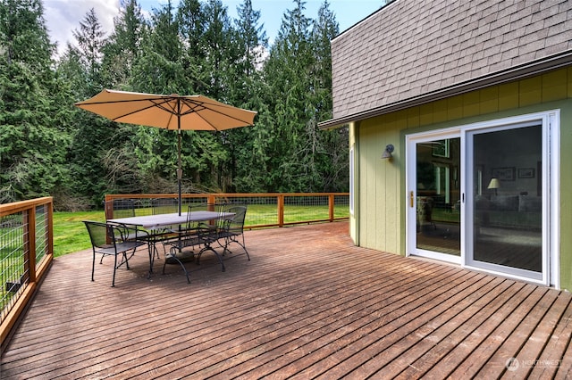 wooden terrace with a yard