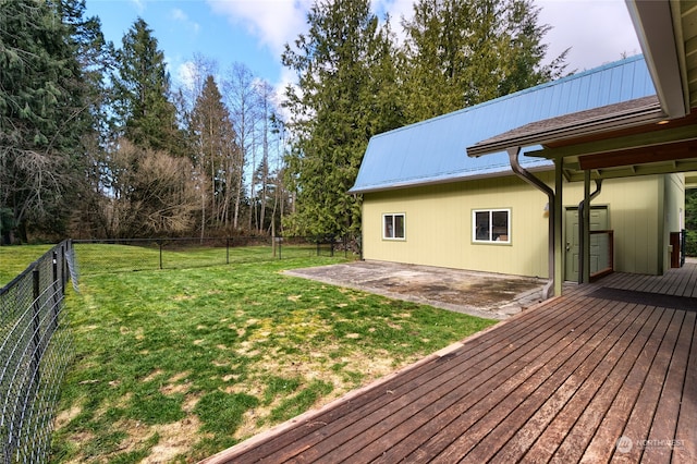 wooden terrace with a lawn and a patio