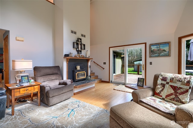 living room with light wood-type flooring and a high ceiling