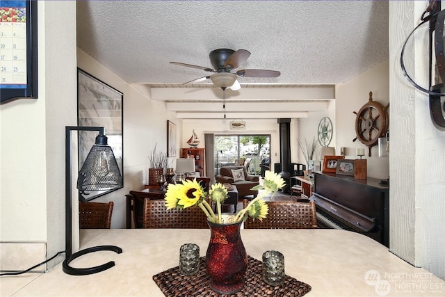 dining room featuring a textured ceiling and ceiling fan