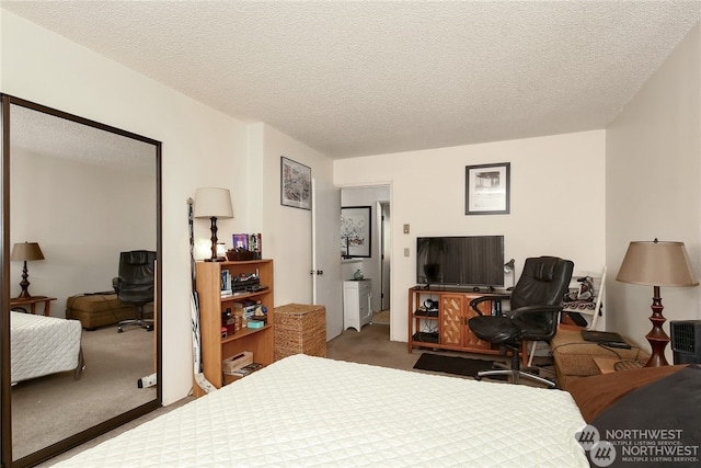 carpeted bedroom featuring a textured ceiling