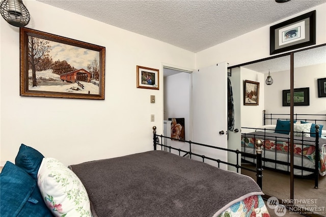 bedroom with a textured ceiling and carpet flooring