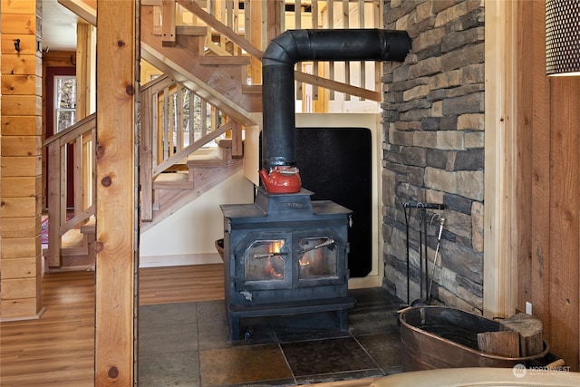 details with a wood stove and dark hardwood / wood-style flooring