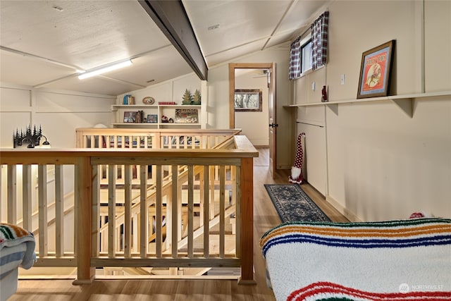 interior space with lofted ceiling and hardwood / wood-style floors