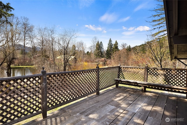 wooden deck featuring a water view