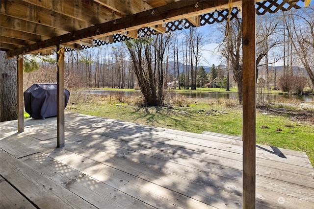 deck featuring a water view and a grill