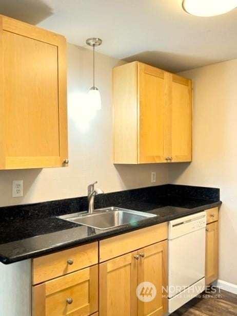 kitchen featuring hanging light fixtures, light brown cabinets, white dishwasher, sink, and dark hardwood / wood-style floors