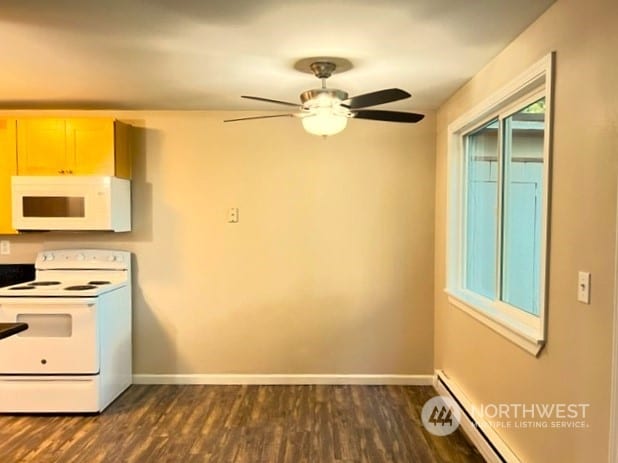 kitchen featuring a baseboard heating unit, dark hardwood / wood-style flooring, ceiling fan, and white appliances