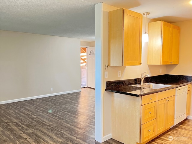 kitchen with light brown cabinets, light hardwood / wood-style floors, pendant lighting, sink, and white dishwasher