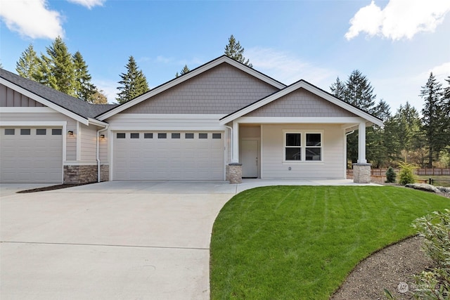 craftsman inspired home featuring a front yard and a garage