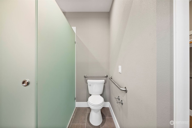 bathroom featuring toilet and tile floors