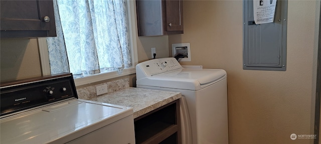 clothes washing area featuring washer hookup, washing machine and dryer, and cabinets