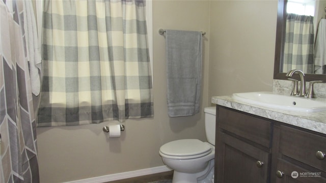 bathroom featuring toilet and vanity