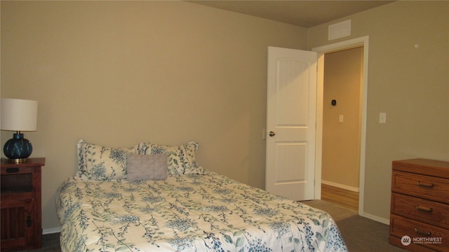 bedroom featuring dark carpet