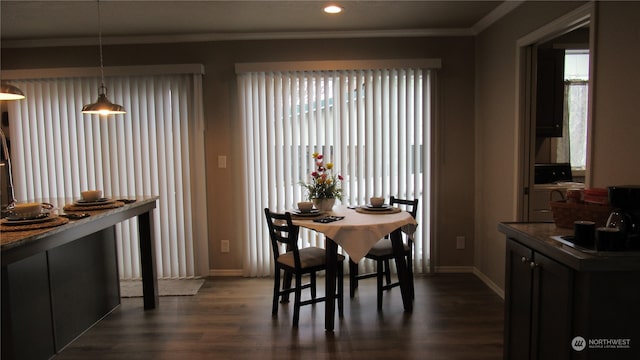 dining area with crown molding and dark hardwood / wood-style flooring