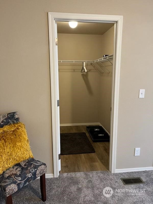 spacious closet featuring dark carpet