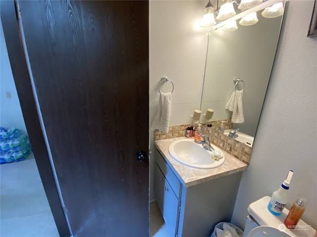 bathroom featuring toilet and large vanity