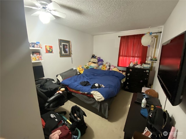 bedroom with a textured ceiling and ceiling fan