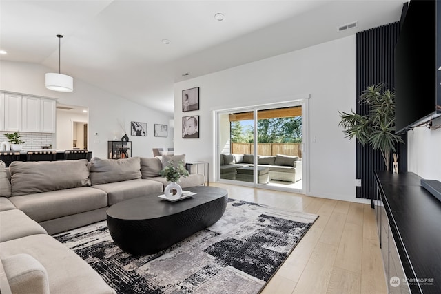 living room with lofted ceiling and light hardwood / wood-style floors