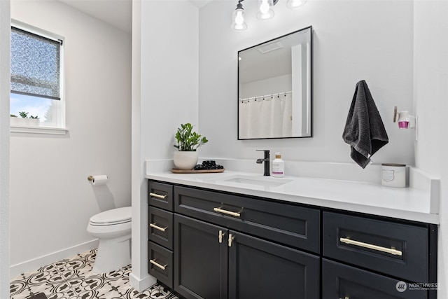 bathroom with tile flooring, toilet, and vanity