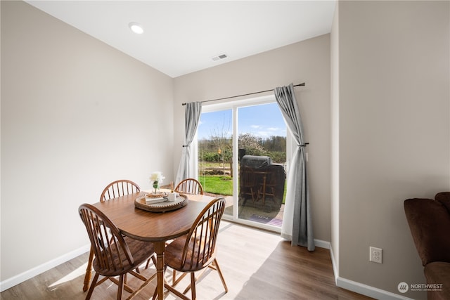 dining space with light hardwood / wood-style floors