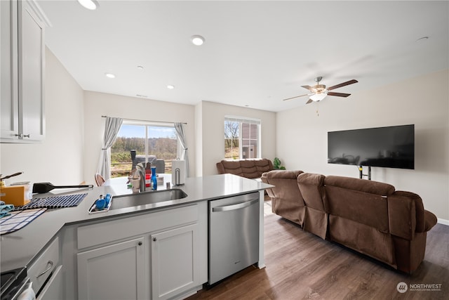 kitchen with stainless steel dishwasher, ceiling fan, hardwood / wood-style floors, white cabinetry, and sink