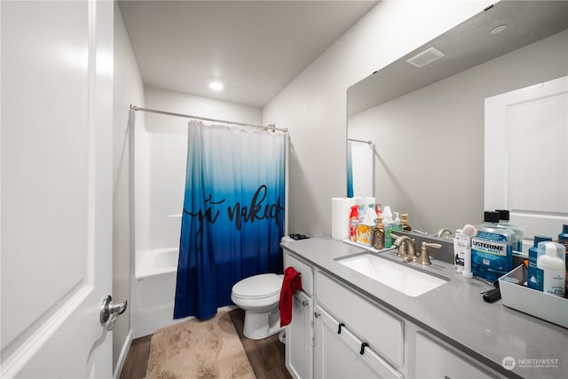 full bathroom featuring shower / bath combination with curtain, large vanity, toilet, and wood-type flooring